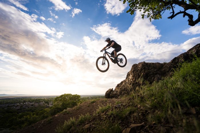 Man jumping mountain bike on Fruit Loops Trail