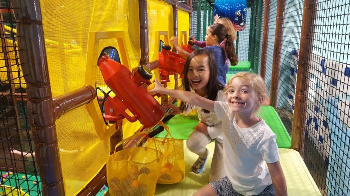 Kids playing with ball cannons at Coconut Cove Amusement Center