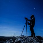 a man stargazing with a telescope at Antelope Island in Utah