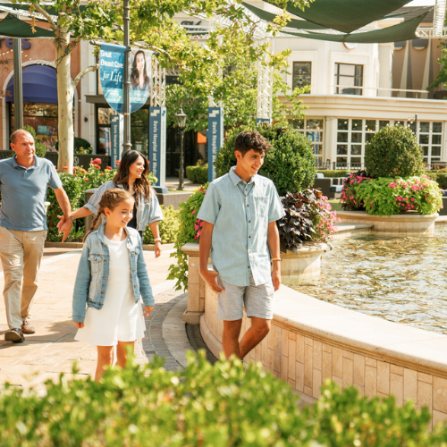 A family walking by the fountain at Station Park