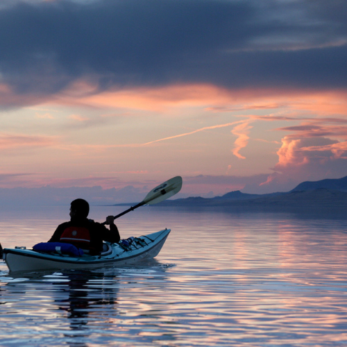 A kayaker enjoys a sunset in the Great Salt Lake