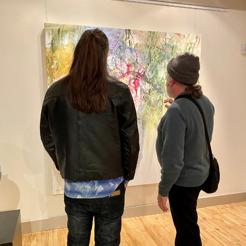 Couple discussing local art exhibit